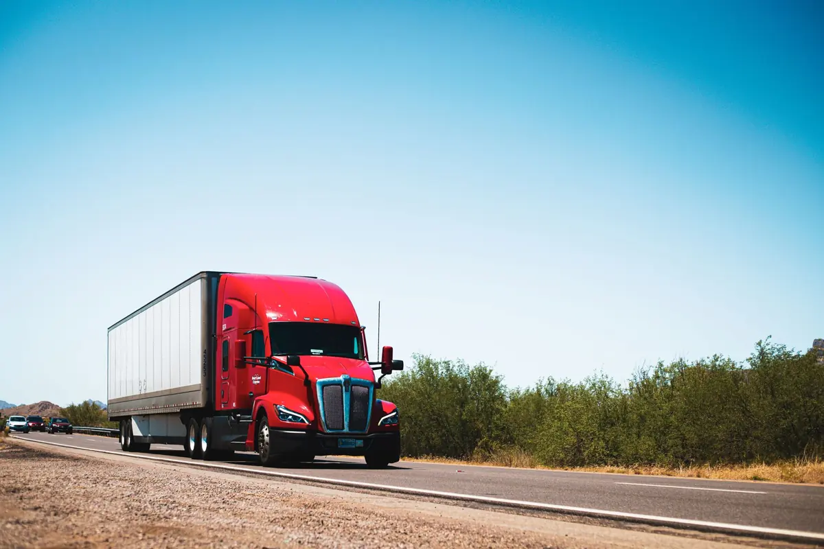 Red semi trailer truck on an open highway